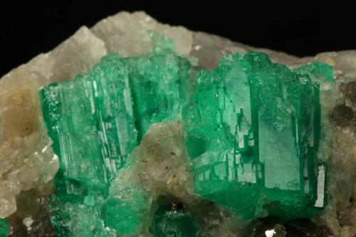 Beryl (variety emerald), Calcite<br />Muzo mining district, Western Emerald Belt, Boyacá Department, Colombia<br />60x47x49mm, central xl=16mm<br /> (Author: Fiebre Verde)