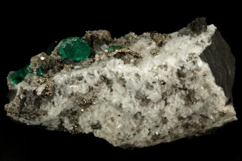 Beryl (variety emerald), Calcite, Pyrite, Albite (variety cleavelandite)<br />Chivor mining district, Municipio Chivor, Eastern Emerald Belt, Boyacá Department, Colombia<br />70x46x34mm, main xl=18mm<br /> (Author: Fiebre Verde)