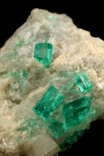 Beryl (variety emerald), Calcite<br />La Pita mining district, Cunas Mine, Municipio Maripí, Western Emerald Belt, Boyacá Department, Colombia<br />42x39x34mm, xls up to 7mm<br /> (Author: Fiebre Verde)