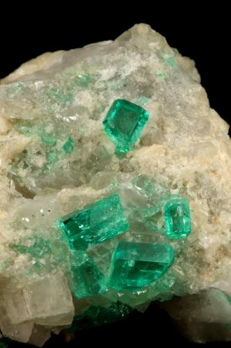 Beryl (variety emerald), Calcite, Dolomite<br />La Pita mining district, Cunas Mine, Municipio Maripí, Western Emerald Belt, Boyacá Department, Colombia<br />42x39x34mm, xls up to 7mm<br /> (Author: Fiebre Verde)