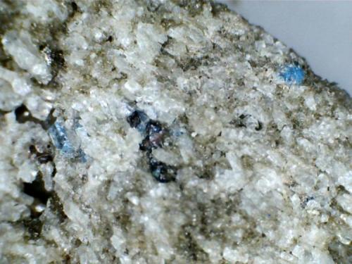 Haüyina (cristal en la cara posterior de la misma roca)
Cantera Dellen (Niedermendig, Mendig, complejo volcánico del Lago Laach, Eifel, Alemania)
20X
Haüyinas azules entre los cristales de sanidina. (Autor: prcantos)