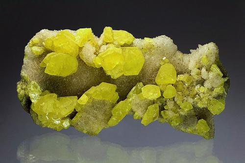 Sulfur on Calcite<br />Provincia Agrigento (Girgenti), Sicilia, Italia<br />65 mm<br /> (Author: Gerhard Brandstetter)