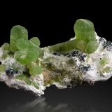 Forsterite (variety peridot)<br />Sapat Gali (Suppat), Naran, Kaghan Valley, Mansehra District, Khyber Pakhtunkhwa, Pakistan<br />9 x 6 x 4.5 cm / main crystal: 2.8 cm<br /> (Author: MIM Museum)