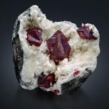 Cinnabar<br />Tongren Prefecture, Guizhou Province, China<br />9.5 x 8 x 10 cm / main crystal: 4.3 cm.<br /> (Author: MIM Museum)