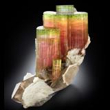 Elbaite with Orthoclase, 'lepidolite', Albite and Quartz (variety smoky)<br />Paprok, Kamdesh District, Nuristan Province, Afghanistan<br />14.5 x 12 x 16 cm / main crystal: 9.2 cm.<br /> (Author: MIM Museum)