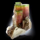 Elbaite with Orthoclase, 'lepidolite', Albite and Quartz (variety smoky)<br />Paprok, Kamdesh District, Nuristan Province, Afghanistan<br />14.5 x 12 x 16 cm / main crystal: 9.2 cm.<br /> (Author: MIM Museum)