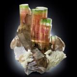 Elbaite with Orthoclase, 'lepidolite', Albite and Quartz (variety smoky)<br />Paprok, Kamdesh District, Nuristan Province, Afghanistan<br />14.5 x 12 x 16 cm / main crystal: 9.2 cm.<br /> (Author: MIM Museum)