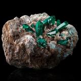 Dioptase with Cerussite and Plancheite<br />Gombe-Lutete, Kongo Central, Democratic Republic of the Congo (Zaire)<br />10.5 x 11 x 6.5 cm / main crystal: 2.5 cm.<br /> (Author: MIM Museum)