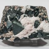 Franklinite with Calcite and Willemite<br />Sterling Mine, Sterling Hill, Ogdensburg, Franklin mining district, Sussex County, New Jersey, USA<br />10.1 × 6.4 × 5.4 cm<br /> (Author: Jordi Fabre)