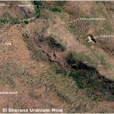 Aerial Photograph of the El Sherana Mine 

Shown is an aerial photograph of the current status of the El Sherana mine. Visible is the camp containing a few derelict buildings. The main open cut is still intact but some areas of the open cut appear to be filled in by natural erosion of the surrounding terrain. Though the area was said to have been ‘rehabilitated’ sometime in the late 80’s or early 90’s the aerial photograph indicates that this was either not done or the work was sub-standard. 

The El Sherana west open cut is still visible, but not as well-defined as seen in a photograph taken in 1963 by UUNL. The area is now overgrown with new and abundant vegetation, which I think, might have a fondness for Uranium. It is also likely that the area may have succumbed to subsidence or natural erosion of the benches. There are no records indicating that UUNL filled in the west open cut after the mine was put on care and maintenance in 1964. Photographs taken by BHP in the late 80’s show that the open cut was heavily overgrown with new flora native to the South Alligator River valley region. According to BHP staff (private communication) the open cuts provided many good homes for the abundant native fauna. Crocodiles you ask, most likely, but who knows?

The site of the Uranium Processing plant some 2 kilometres SE of the main camp (not shown in the above aerial photograph) was covered in soil in the late 80’s or early 90’s. The buildings on the site were demolished and the remains buried. This attempt to ‘rehabilitate’ can be seen in aerial photographs but it would appear that even here the mine is fighting back.

Height above sea level for some locations is given in metres. 

Main open Cut Digital GPS location: -13.50932, 132.52067 (Author: silvia)