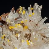 Fan-like aggregates and radial groups of flattened Hemimorphite crystals with excellent terminations. They are very well defined, separate, transparent, and bright, and are on a limonite matrix with small, intensely yellow bow-tie Mimetite groups.

Ojuela is an epithermal polymetallic deposit hosted in Mesozoic limestones of the Aurora Group, associated with low-sulfidation hydrothermal systems with silver, lead, zinc, and secondary arsenate mineralization. The mine is world-famous for the exceptional diversity and quality of its secondary species, and it is the type locality for numerous mineral species.
Among its most emblematic species are Hemimorphite, Adamite, Legrandite, Aurichalcite, Smithsonite, and many others... (Author: Jordi Fabre)