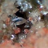 Shijiangshanita, Calcita<br />Mina Shijiangshan, zona media número 8 (pozo central), Aldea Shijiangshan, Yinwu, Linxi, Ulanhad League, Región Autónoma Mongolia Interior, China<br />Campo de visión 3 mm.<br /> (Autor: Antonio P. López)