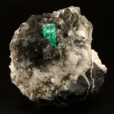 Beryl (variety emerald), Calcite, PyriteLa Pita (distrito minero), Mina Cunas, Municipio Maripí, Cinturón Esmeraldífero Occidental, Departamento Boyacá, Colombia50x50x45mm, xl=11x7mm (Author: Fiebre Verde)