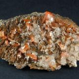 Wulfenite with Calcite on BaritePure Potential Mine, Silver District, Trigo Mountains, La Paz County, Arizona, USA70 x 37 x 39 (Author: GneissWare)
