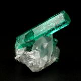 Beryl (variety emerald), Calcite<br />La Pita mining district, Polveros Mine, Municipio Maripí, Western Emerald Belt, Boyacá Department, Colombia<br />main xl=18x4.5mm<br /> (Author: Fiebre Verde)