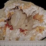 Calcite with Marcasite inclusions on Dolomite and QuartzState Route 37 road cuts, Harrodsburg, Clear Creek Township, Monroe County, Indiana, USAgeode is about 14 cm,  cavity is about 10 cm, largest calcite is about 4.5 cm (Author: Bob Harman)