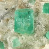 Beryl (variety emerald), Calcite, Aragonite<br />Chivor mining district, Municipio Chivor, Eastern Emerald Belt, Boyacá Department, Colombia<br />75x63x64mm, main xl=11x9mm<br /> (Author: Fiebre Verde)