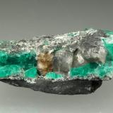 Beryl (variety emerald), Dolomite, Parisite-(Ce)<br />Muzo mining district, Western Emerald Belt, Boyacá Department, Colombia<br />39x12x22mm, Parisite=5mm, largest Beryl=12mm<br /> (Author: Fiebre Verde)