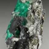 Beryl (variety emerald), Calcite, Pyrite<br />Coscuez mining district, Calceteros Mine, Municipio San Pablo de Borbur, Western Emerald Belt, Boyacá Department, Colombia<br />29x45x27mm, xl=34mm<br /> (Author: Fiebre Verde)