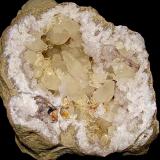 Calcite, Barite and Dolomite on QuartzState Route 37 road cuts, Harrodsburg, Clear Creek Township, Monroe County, Indiana, USAgeode is 22 cm x 18 cm. The largest doubly terminated calcite (near the cavity center) is 7 cm (Author: Bob Harman)