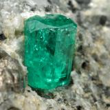 Beryl (variety emerald), Calcite<br />La Pita mining district, Cunas Mine, Municipio Maripí, Western Emerald Belt, Boyacá Department, Colombia<br />27x33x35mm, xl=9mm<br /> (Author: Fiebre Verde)