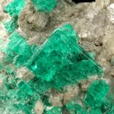 Beryl (variety emerald), Calcite, Muscovite<br />La Pita mining district, Cunas Mine, Municipio Maripí, Western Emerald Belt, Boyacá Department, Colombia<br />40x63x47mm, largest xl=14x11mm<br /> (Author: Fiebre Verde)