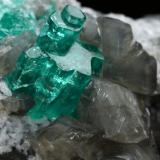 Beryl (variety emerald), Calcite, Dolomite<br />La Pita mining district, Cunas Mine, Municipio Maripí, Western Emerald Belt, Boyacá Department, Colombia<br />33x20x23mm, main aggregate=10x9mm<br /> (Author: Fiebre Verde)