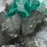 Beryl (variety emerald), Calcite, Dolomite<br />La Pita mining district, Cunas Mine, Municipio Maripí, Western Emerald Belt, Boyacá Department, Colombia<br />33x20x23mm, main aggregate=10x9mm<br /> (Author: Fiebre Verde)