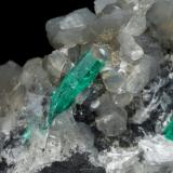 Beryl (variety emerald), Calcite, Dolomite<br />La Pita mining district, Cunas Mine, Municipio Maripí, Western Emerald Belt, Boyacá Department, Colombia<br />47x45x47mm, xl=18mm - 2 xls in the back: 11mm & 7mm<br /> (Author: Fiebre Verde)