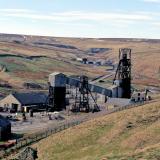 Frazer’s Hush was a modern mine, operating between 1974 - 1999. It was located at the far northwest end of Rookhopeburn, just beyond the Groverake Mine. The workings can be seen in the middle background of the photo, just left of the main Groverake head frame. The Frazer’s Hush workings were declines rather than shafts, so no head frames were erected on site. The mine is best known for a find of high quality purple fluorites that happened in 1987-1988. The photo was taken in 1999 shortly after the closure of both mines. The sites have largely been cleared since, and the only thing that now remains is the main Groverake head frame. (Author: Jesse Fisher)