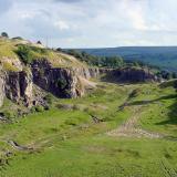 A view of the western extension of the Rogerley Quarry, taken in 2002. The Sutcliffe Vein is the larger of the two ribs of rock extending from the quarry face. The smaller rib, to the left of the Sutcliffe has never to my knowledge been prospected.  I understand that the site looks a bit different now, after recent work. (Author: Jesse Fisher)