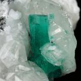 Beryl (variety emerald), Calcite<br />Muzo mining district, Western Emerald Belt, Boyacá Department, Colombia<br />45x47x32mm, xl=15mm<br /> (Author: Fiebre Verde)