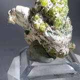 Andradite (variety demantoid), asbestos<br />Sferlùn asbestos Mine, Vallone del Cengiaccio, Lanzada, Malenco Valley (Valmalenco), Sondrio Province, Lombardy, Italy<br />33 x 32 mm<br /> (Author: Sante Celiberti)