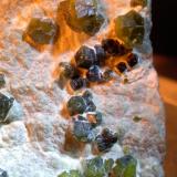 Andradite (variety demantoid), Asbestos<br />Sferlùn asbestos Mine, Vallone del Cengiaccio, Lanzada, Malenco Valley (Valmalenco), Sondrio Province, Lombardy, Italy<br />44 x 52 mm<br /> (Author: Sante Celiberti)