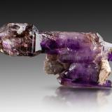 Quartz (variety amethyst)<br />Brandberg area, Erongo Region, Namibia<br />4.5 x 3 x 11 cm / main crystal: 11cm<br /> (Author: MIM Museum)