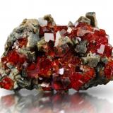 Grossular (variety hessonite)<br />Belvidere Mountain Quarries, Lowell & Eden, Orleans and Lamoille Counties, Vermont, USA<br />6 x 5 x 8.5 cm / main crystal: 1.6 cm<br /> (Author: MIM Museum)