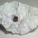 Red Beryl. Utah. Translucent crystal with very even red color.  17.5 x 11.9 x 6.7 cm overall.  2.1 x 1.4 x 1.6 cm crystal. (Author: GneissWare)