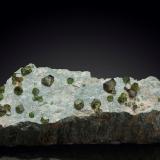 Andradite (variety demantoid)Mina Sferlùn asbestos, Vallone del Cengiaccio, Lanzada, Valmalenco, Provincia Sondrio, Lombardía, Italia19.5 x 7 x 5.5 cm / main crystal: 1.4 cm (Author: MIM Museum)