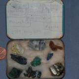 Here they are, my first minerals, kept in a tobacco tin. 
I put it into a pipe tobacco tin. Here’s a photo of the outside of the tin, just for grins. Locality info? Who knows? Except for the specular hematite (Mesabi range) and the selenite (Jet, Oklahoma), everything else is simply quien sabe? Keep in mind that I was 12 yrs old at the time, and lacking any sort of mineralogical mentoring. Later, when at Norman, Oklahome, I hung aroung the geology department there, and Bill Hiss took me under his wing, set me on the right path, so to speak. (Author: Ed Huskinson)