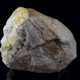 The back of the specimen, primarily a limestone matrix with the yellow fluorite and white calcite covering one side. (Author: k-m.minerals)