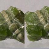 Olivine series, Forsterite var.Peridot with Calcite; Sapat Gali (Soppat), Kohistan, Pakistan.
50x35x33mm, 56g. GN&rsquo;s collection id 09PKOcm01.
Taken in direct sunlight. Stereo pair. (Author: Gerhard Niklasch)