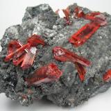 Realgar, stibnite
Baia Sprie (Felsöbánya), Maramures, Romania
106 mm x 71 mm. Main crystal: 9 mm wide, 24 mm long (Author: Carles Millan)