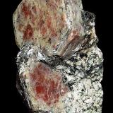 Corundum ( var. Ruby )

Sagstuen
Farsjø
Årnes, Akershus Fylke (Province)
Norway

5.5 x 3.1 cm overall
3.0 cm crystal (Author: GneissWare)