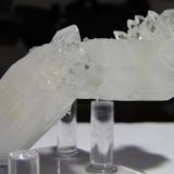 Two large, opaque fluorapophyllite crystals (and a third, smaller one) stuck together at a strange angle with smalller crystals attached and covered by scattered stilbite bowties about 2 mm long.  From Jalgaon, Maharashtra, India.  Approx. 92 x 36 x 30 mm. (Author: Tracy)