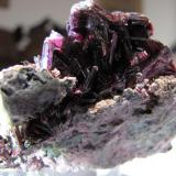 Erythrite crystals on matrix from Bou Azzer area, near Ouarzazate, Morocco.  5.7 x 4.7 x 4.4 cm.  From the 2009 Munich show. (Author: Tracy)