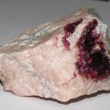 Roselite on pink calcite from Bou Azzer area, near Ouarzazate, Morrocco.  6.1 x 4.3 x 3.6 specimen.  From the 2009 Munich show. (Author: Tracy)