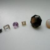 German cut stones. From the left to the right: magnetite (3,1 ct) from Volkesfeld, Eifel mts. - sanidine (3,2 ct) from the same locality - amethyste (2,7 ct) from Seidelgrund, Wiesenbad, Erzgebirge, Saxony - topaz (1,9 ct) from Schneckenstein, Saxony - smoky quartz (23,6 ct) from Elzing quarry, Limbach, Saxony  - opal from Eibenstock, Saxony which has been a well-known deposit for gemmy opals in the past. (Author: Andreas Gerstenberg)