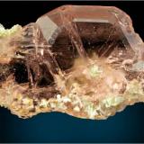 What on first glance looks like morganite is actually a gemmy light pink/red spinel twin fluorite from Gilgit , Pakistan with some minor clusters of muscovite. This measures 9.8 x 5.5 x 3.5 cm and weighs around 125 grams. (Author: VRigatti)