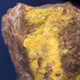 As is the case with most of my type locality minerals this is not real showy. The bright yellow crust is Pottsite from  Linka Mine, Spencer Hot Springs District, near Potts, Lander county, Nevada. The piece is about 1 1/8" x 1" (2.86 x 2.54 cm) (Author: Jim Prentiss)