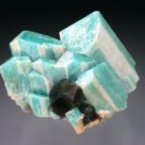 Microcline (Amazonite) with Smoky Quartz, Lake George, Park County, CO. Microcline shows "striped" white overgrowth (likely albite) of selected faces. 4x4x3 cm overall size. (Author: Jesse Fisher)